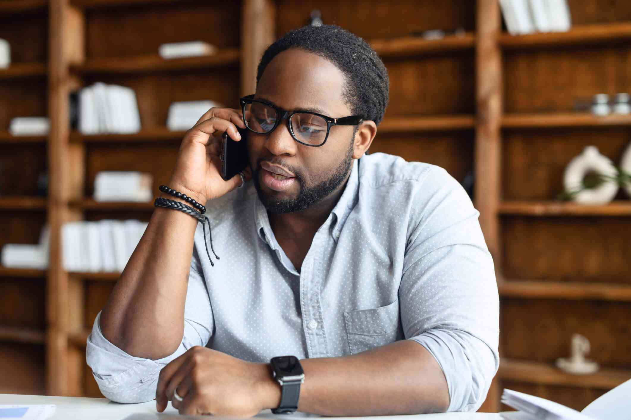 Man on phone receiving remote counselling